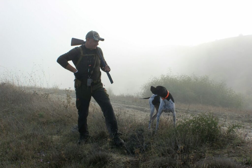 Male hunter with a dog companion
