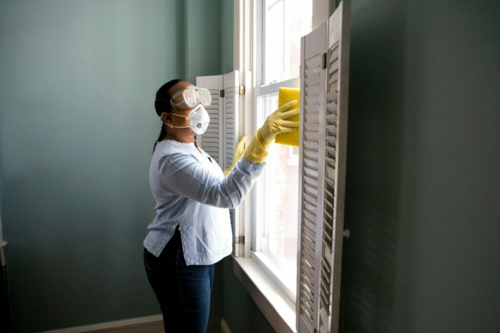 Woman cleaning and wiping the window 