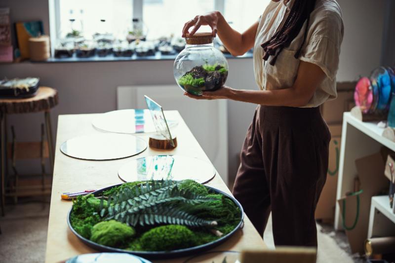Woman with terrarium in hand