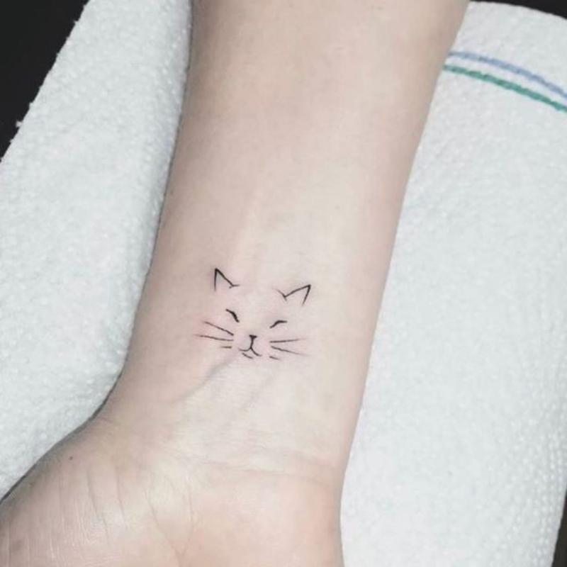 Inked Whiskers: 25 Unique Cat Tattoo Designs 2 Cat face minimalist
