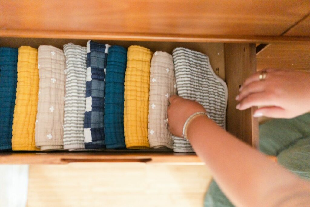 Putting clothes on a wooden drawer