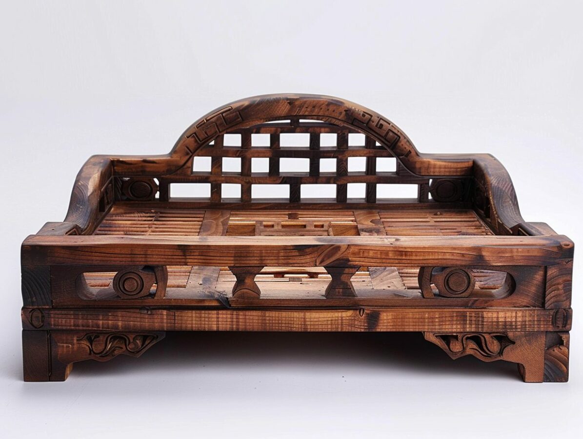 Exquisite Chinese wooden daybed with intricate carvings on a white background.